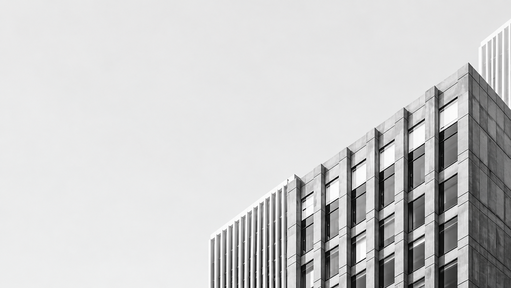 Modern building facade against a pale sky
